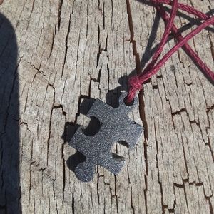 Dark grey/black matte puzzle piece necklace
